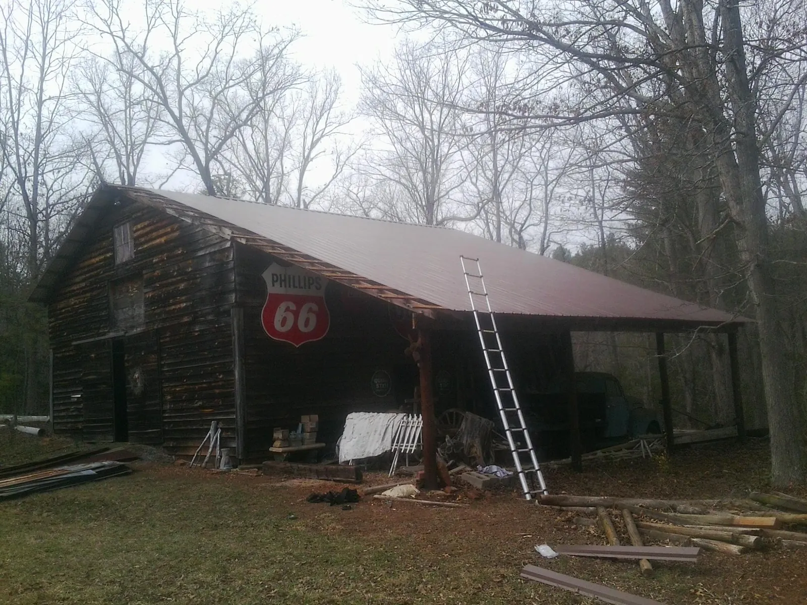 New metal roof on an open sided timber barn with a vintage sign in Rosemont